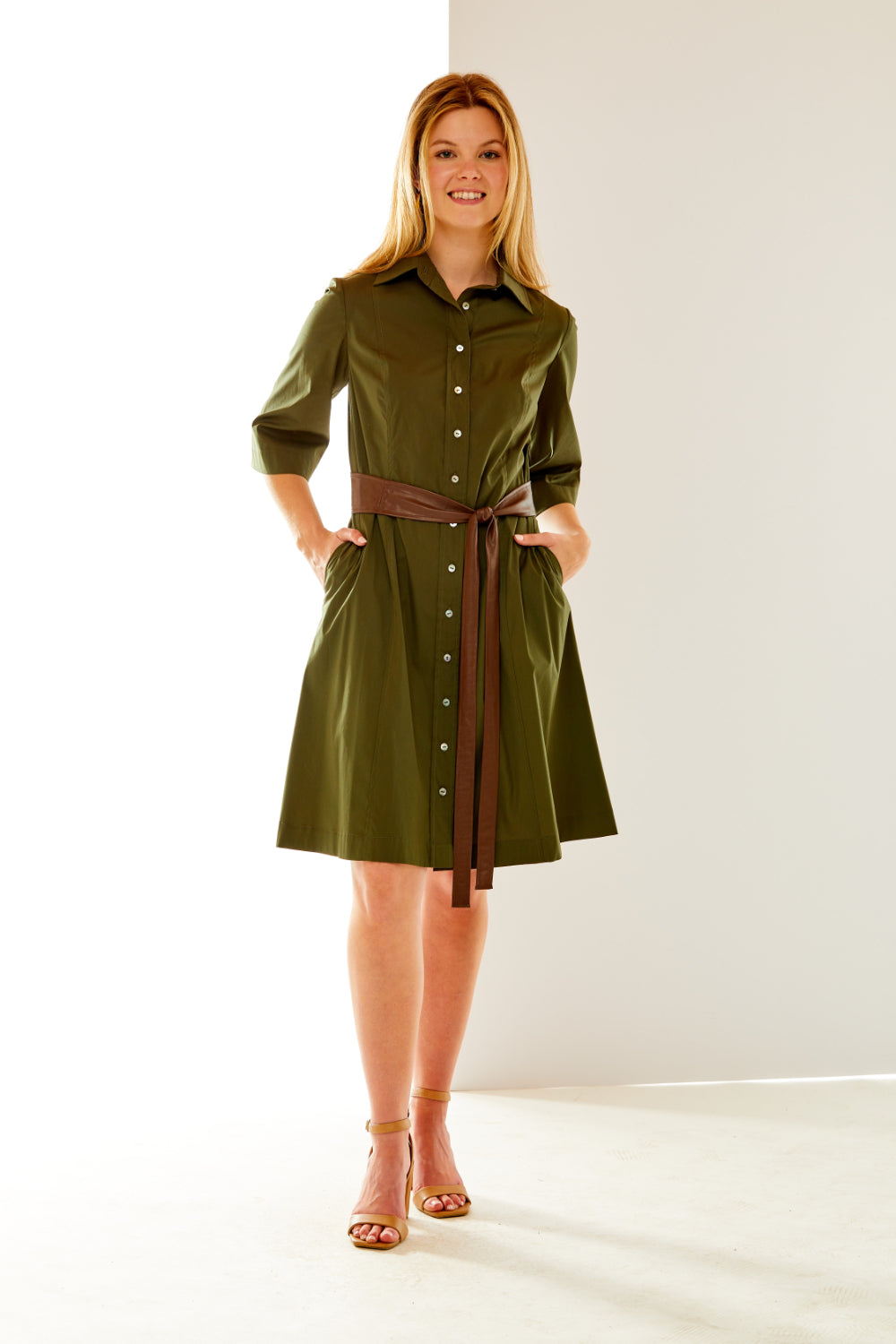 Woman in olive dress with faux leather sash