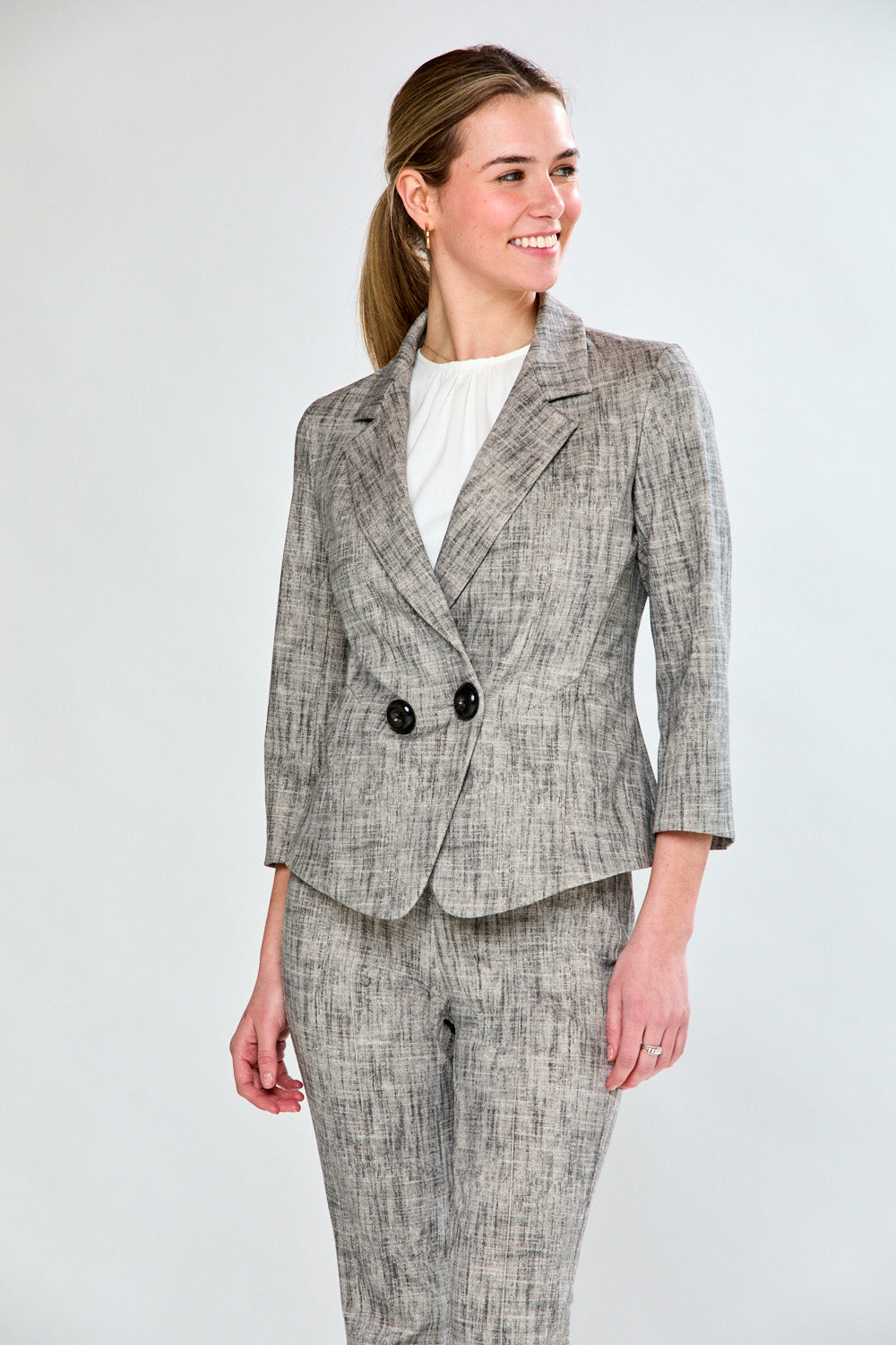 Woman wearing sand and black jacket
