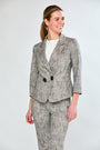Woman wearing sand and black jacket