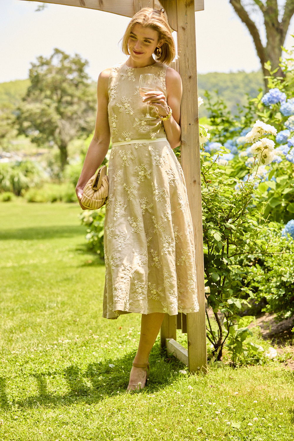 Woman wearing a beige embroidered dress