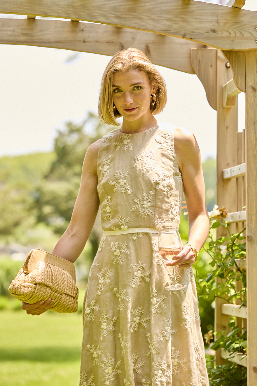 Woman wearing a beige embroidered dress
