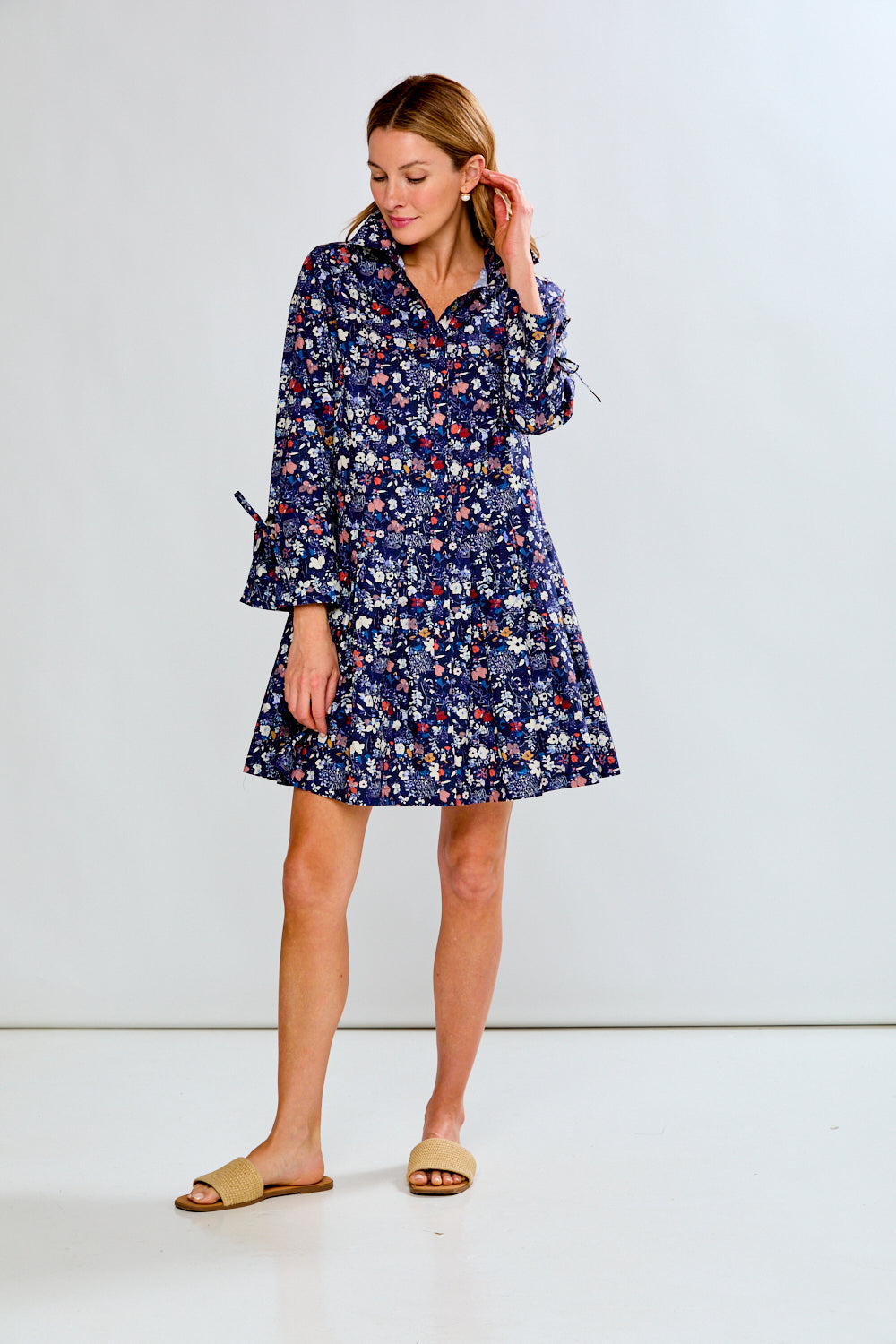 Woman wearing a floral dress against a white background