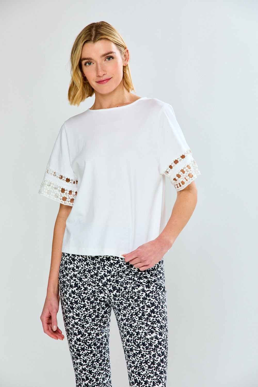 Woman in white top and printed pants