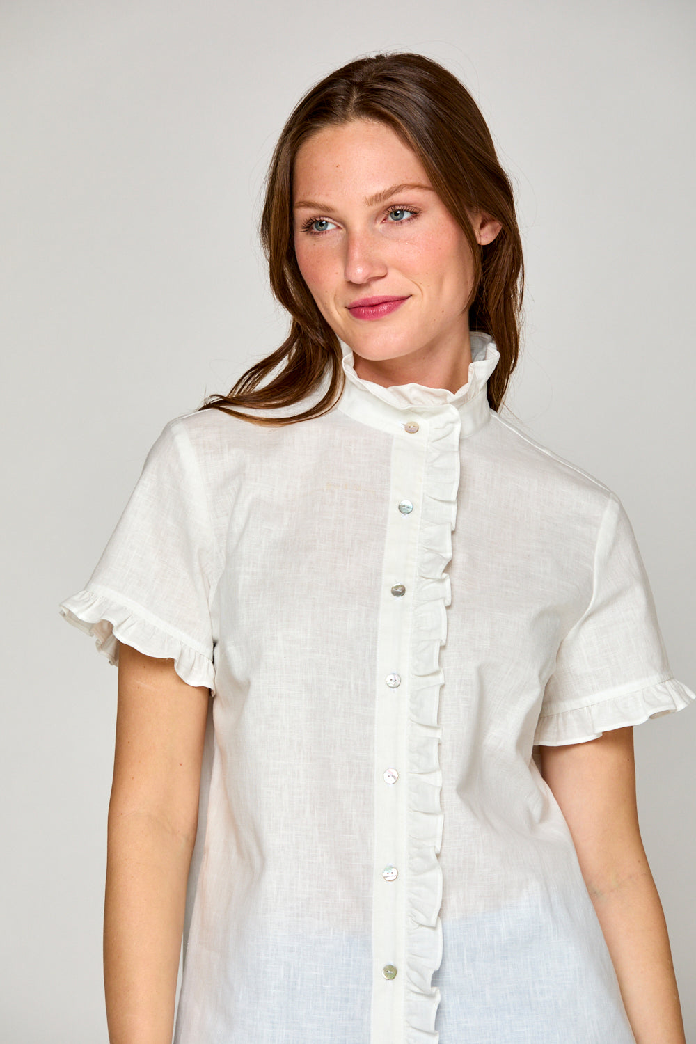 Woman in white short sleeve linen blouse