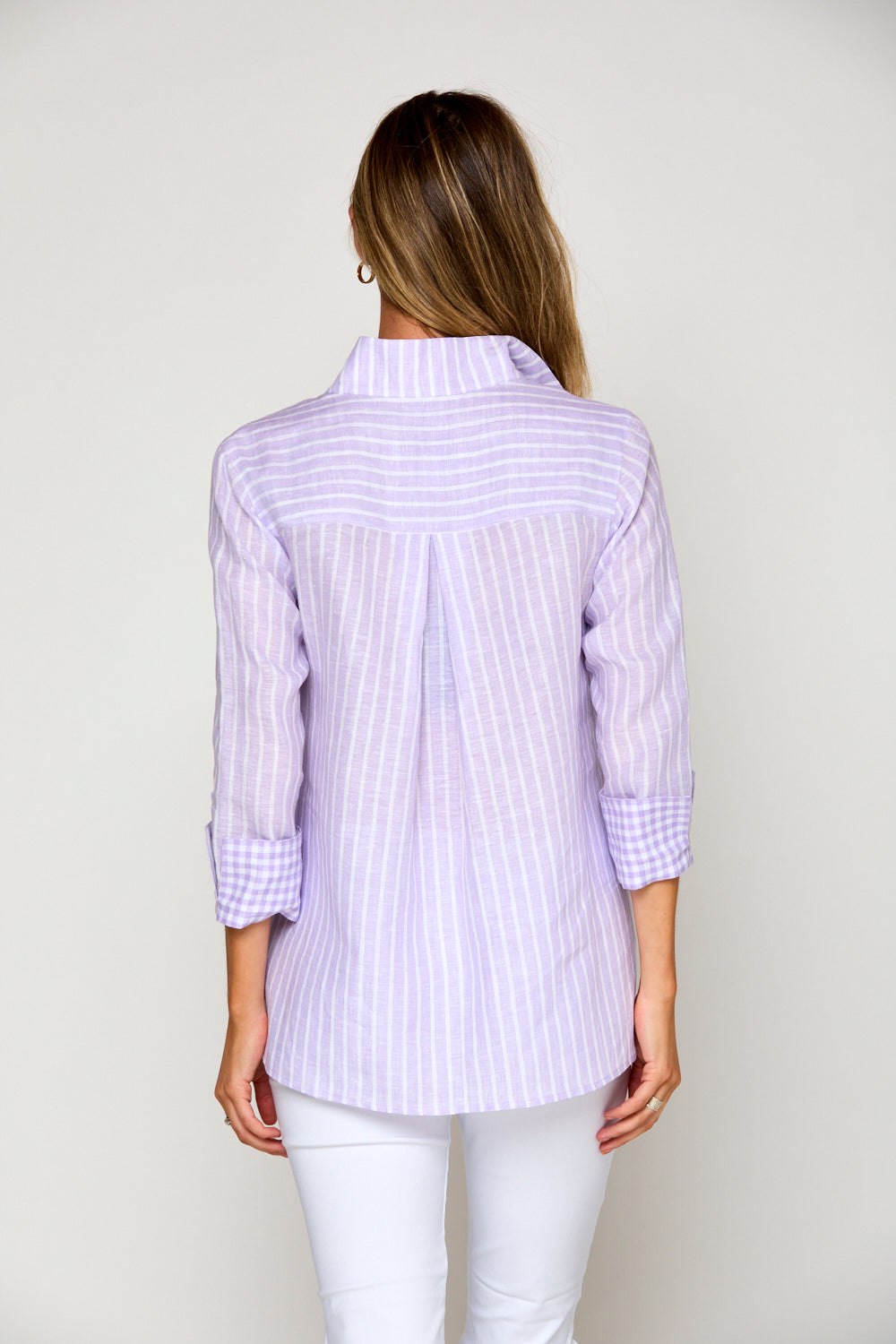 Woman in purple and white striped blouse