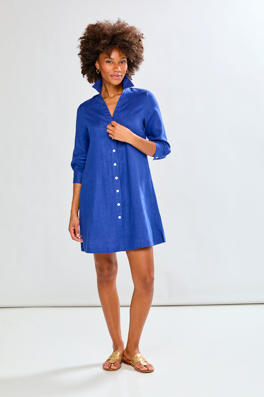 Woman wearing a blue dress against a white background