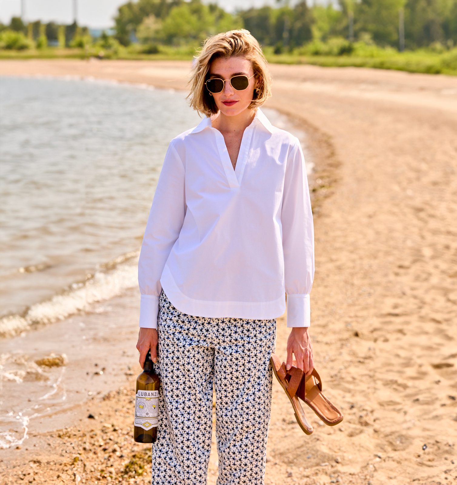 Woman wearing a white blouse on the beach