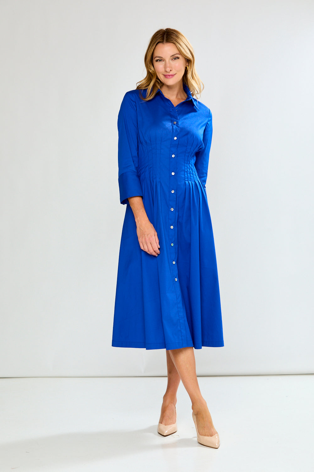 Woman wearing a blue dress against a white background