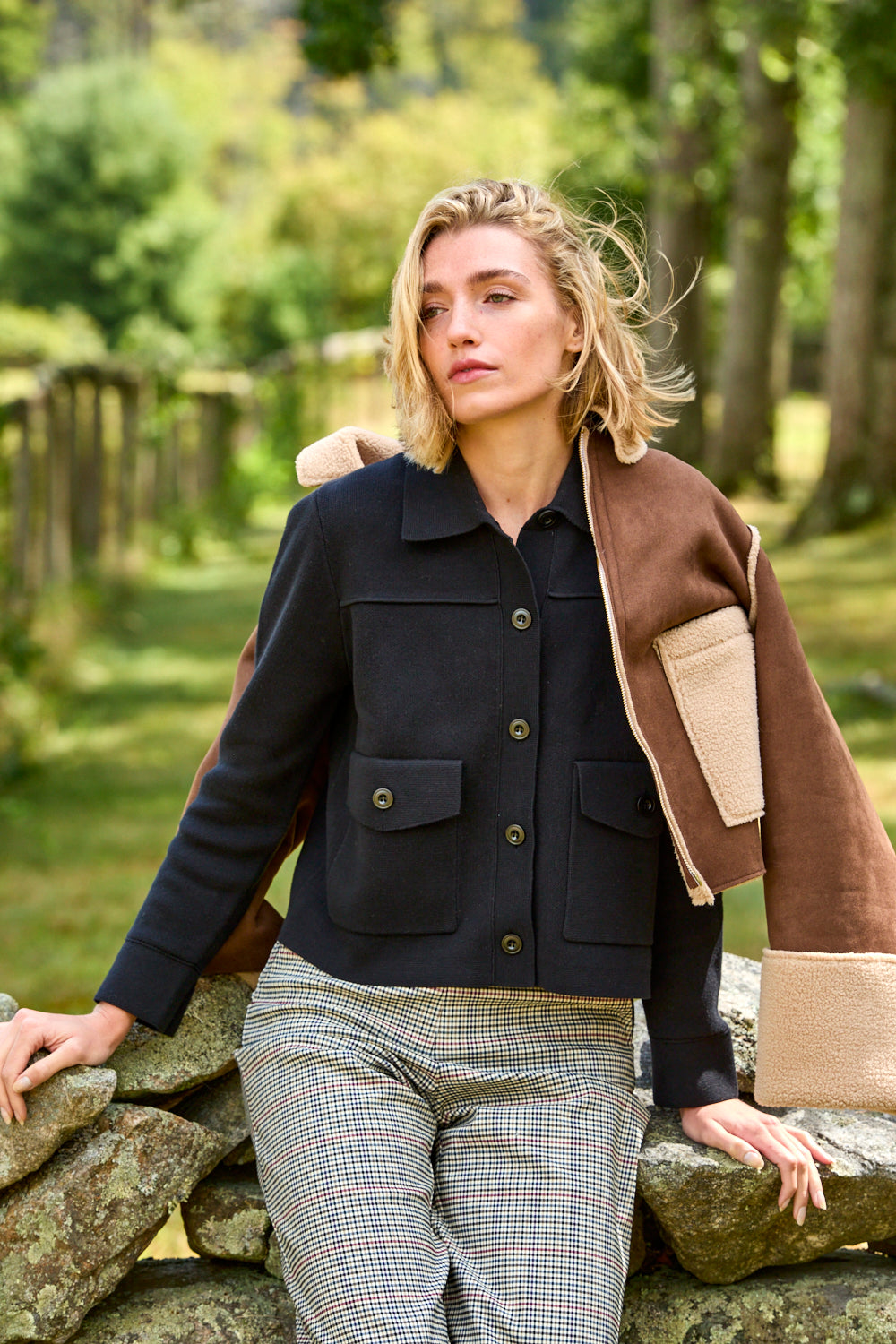 Woman wearing a black sweater jacket with pockets