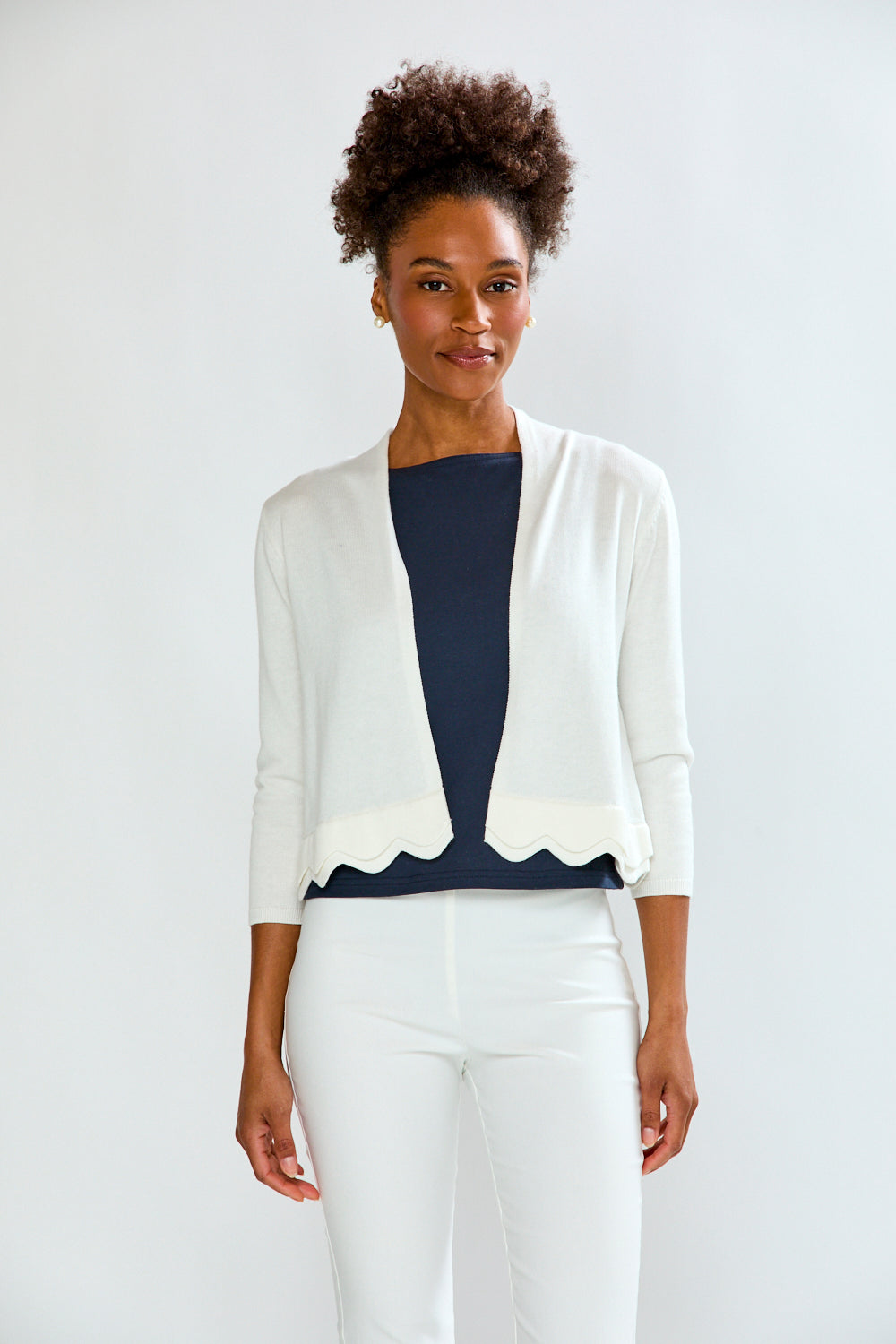 woman in white scalloped sweater