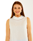 Woman in white mock neck top