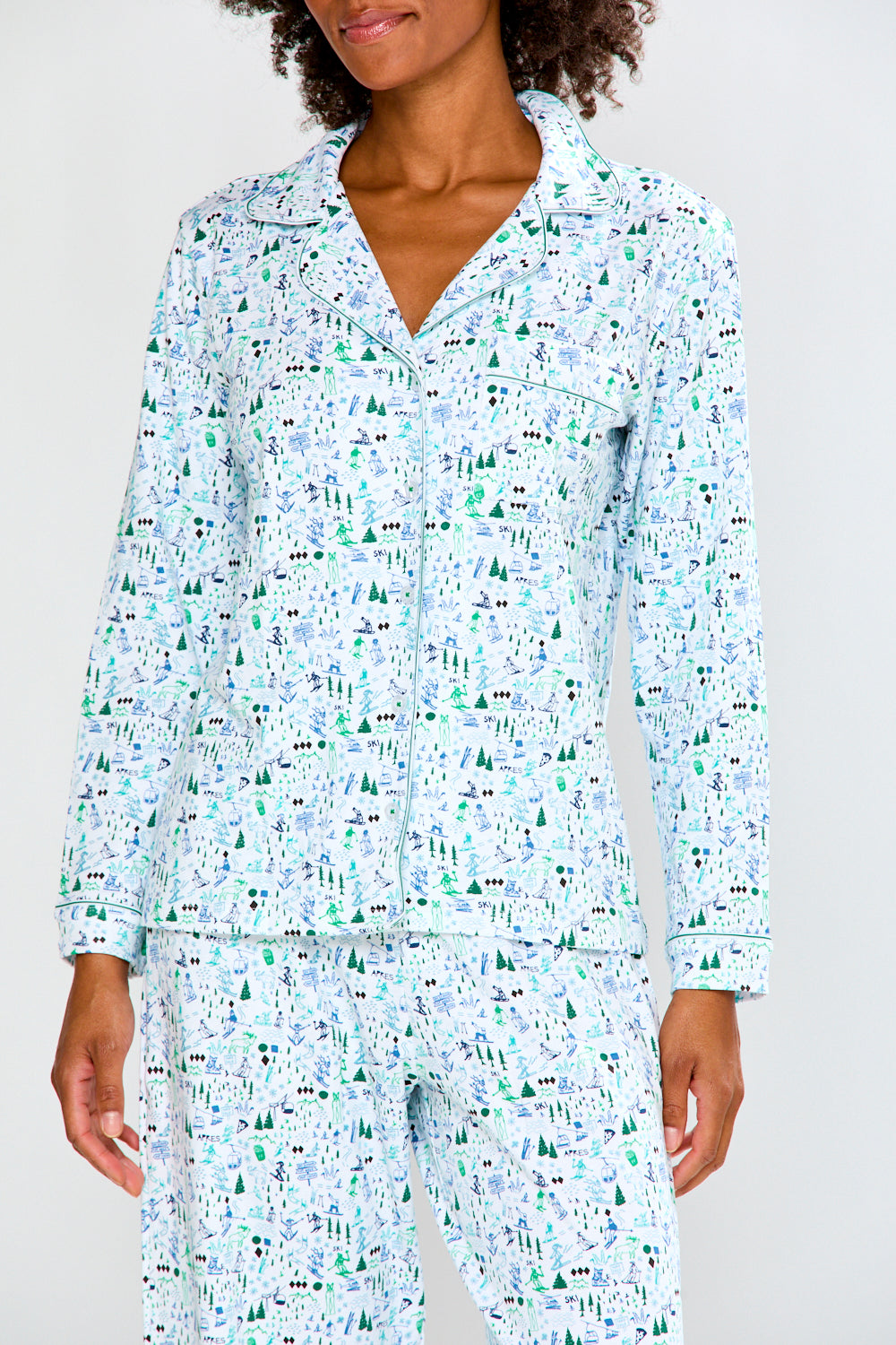 Woman wearing a light blue pajama set on a white background