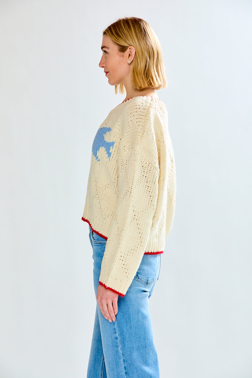 Woman with cream fish sweater on