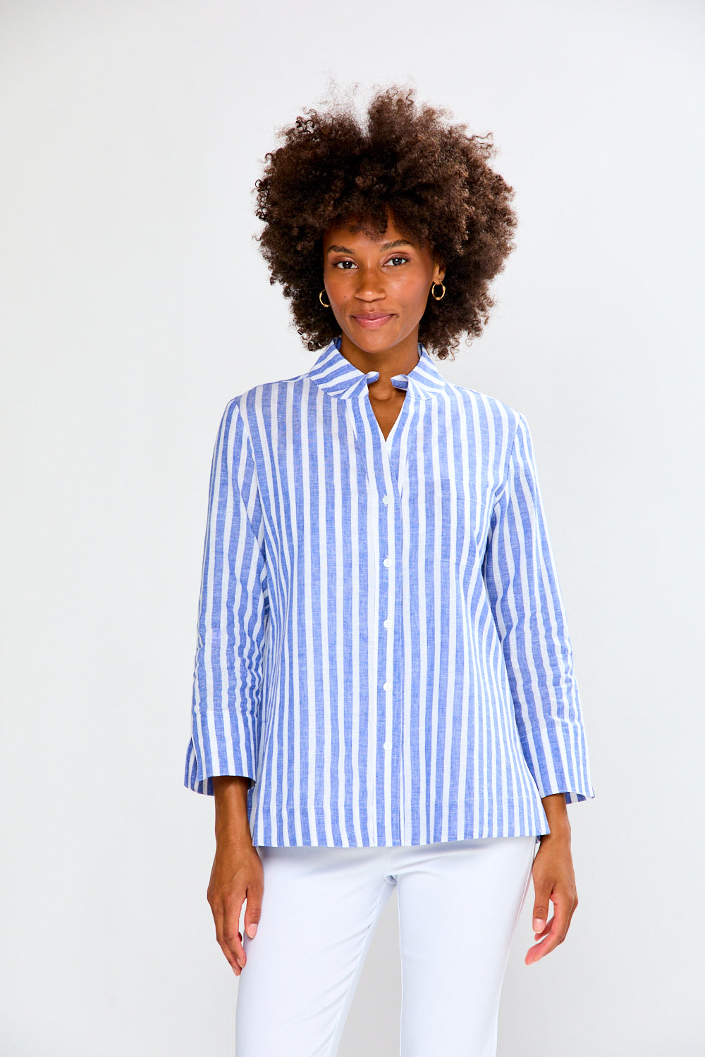 Woman wearing a blue and white striped shirt against a white background