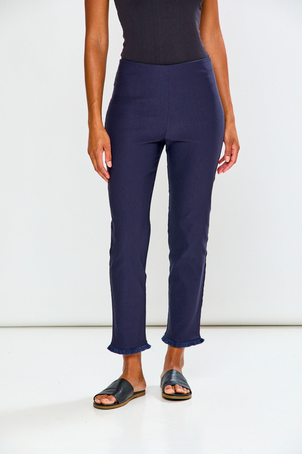 Woman wearing navy blue pants on a white background