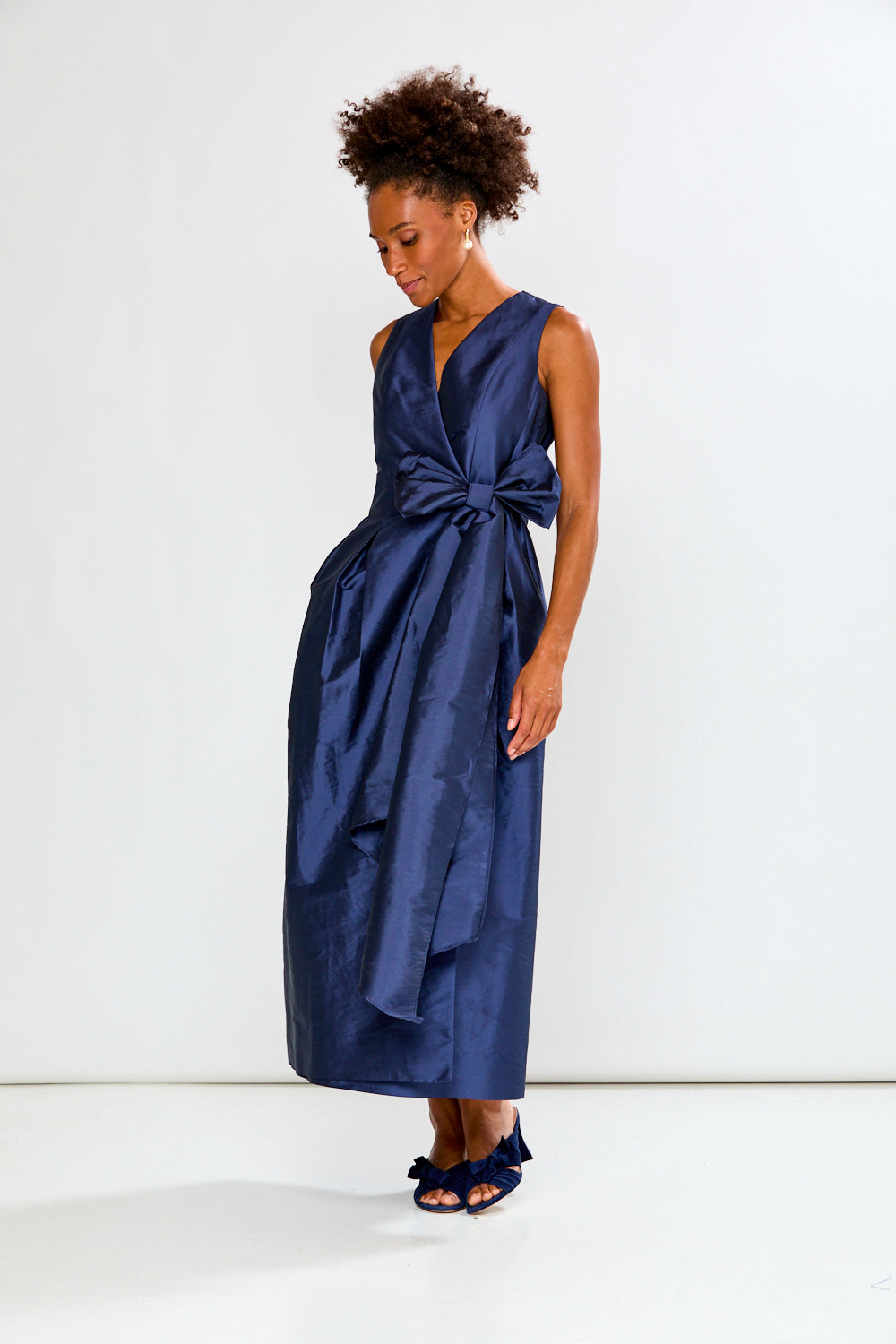 Woman wearing a blue dress with a white background