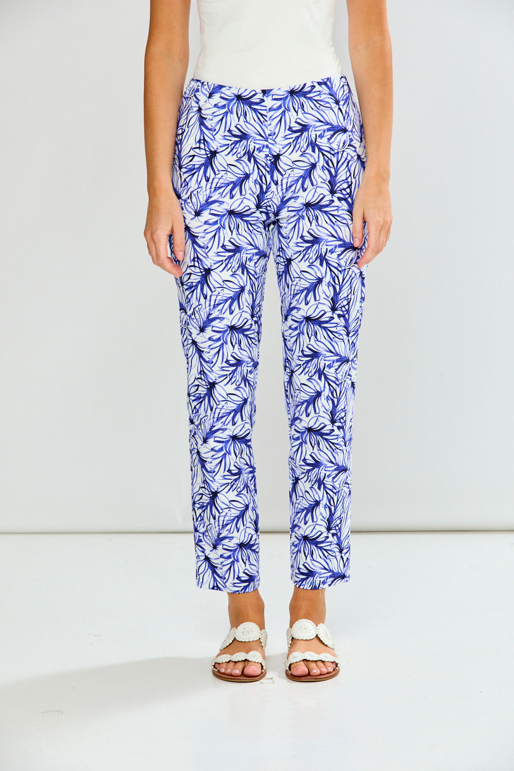 Person wearing blue floral pants on a white background