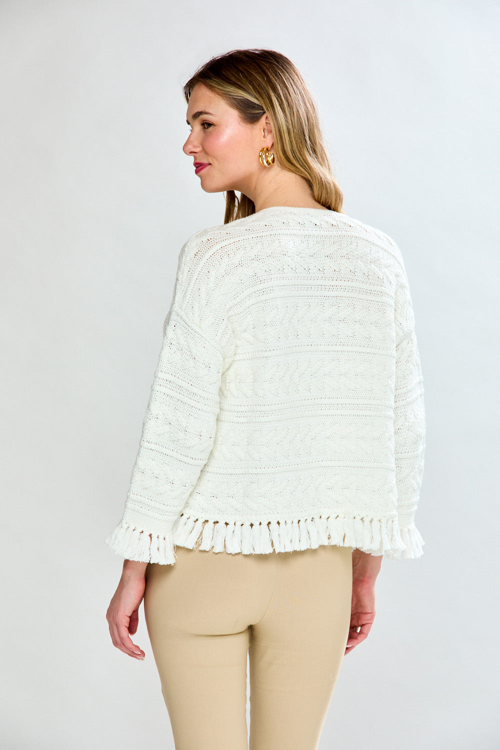 Woman in white fringe cardi