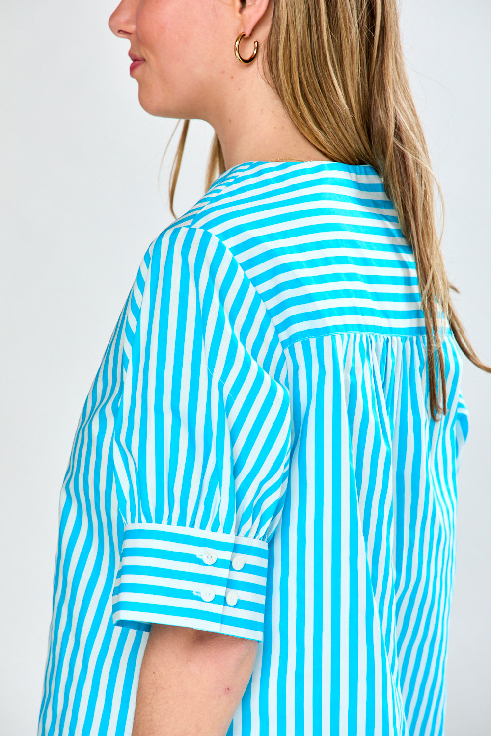 Woman in aqua stripe top