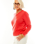 Woman in coral v neck pullover