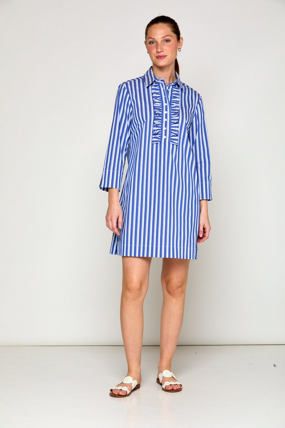 Woman in blue and white stripe dress