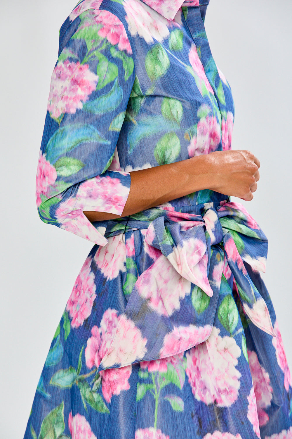 Woman in tea length floral dress