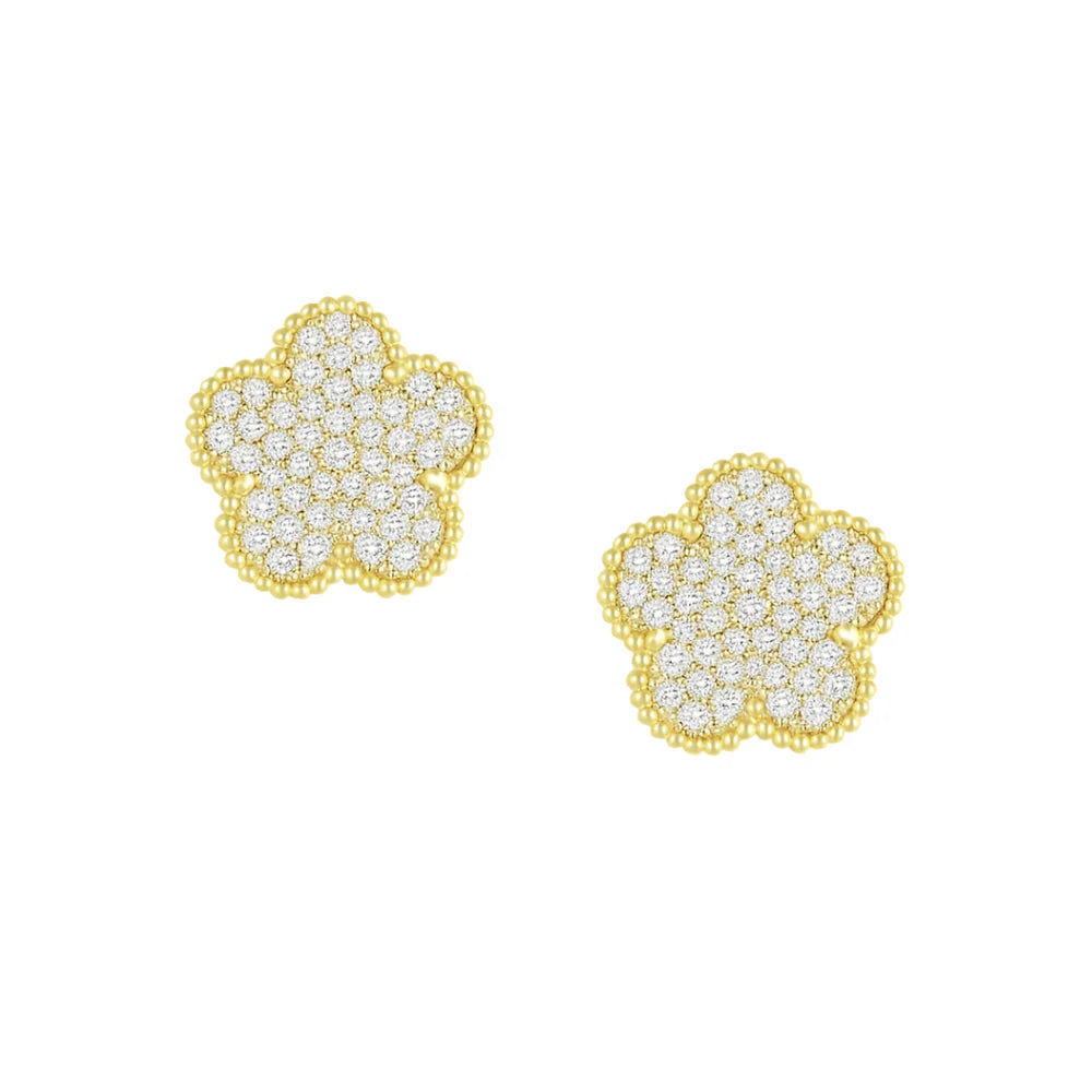 Gold flower-shaped earrings with clear gemstones on a white background