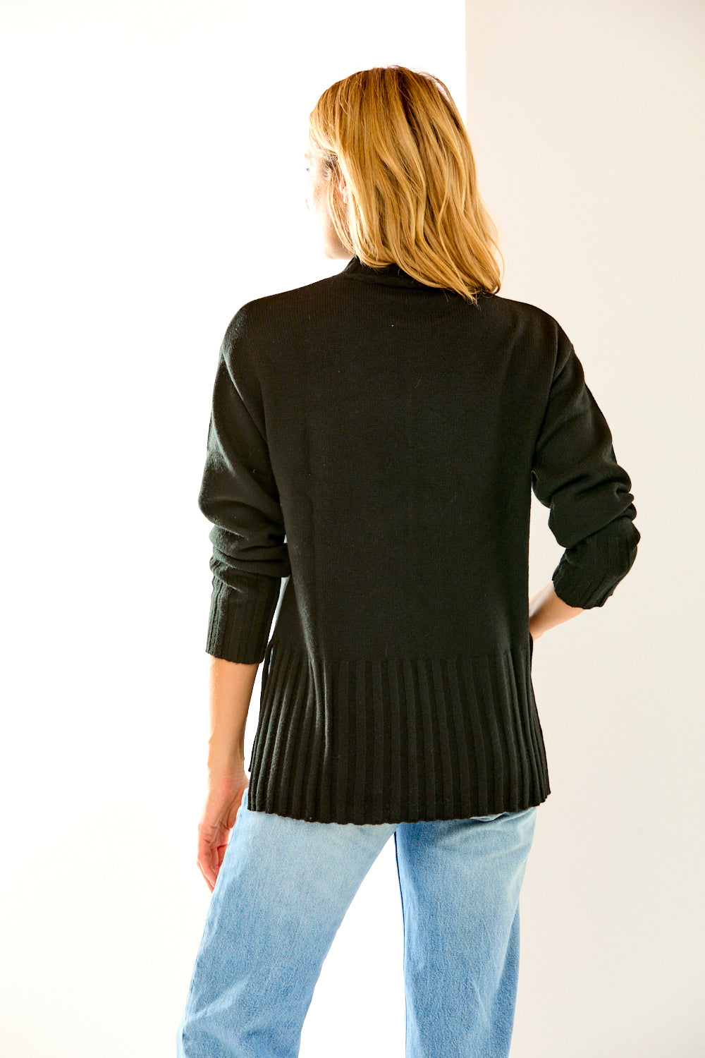 Woman in black cashmere turtleneck