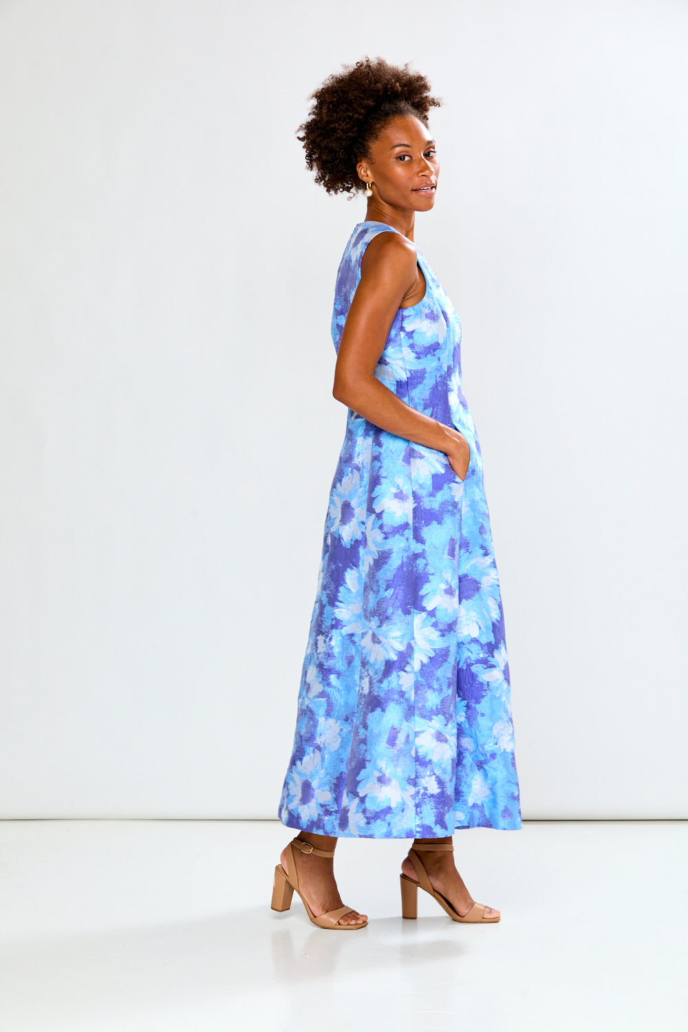 Woman wearing a blue floral dress on a white background