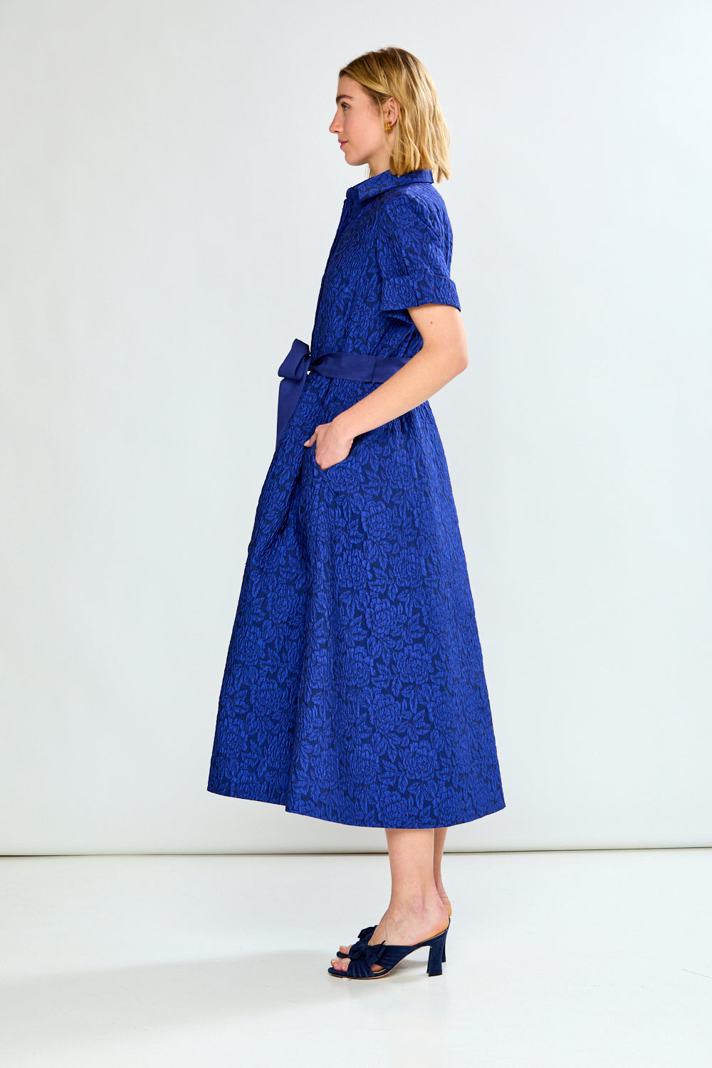 Woman in blue dress with bow