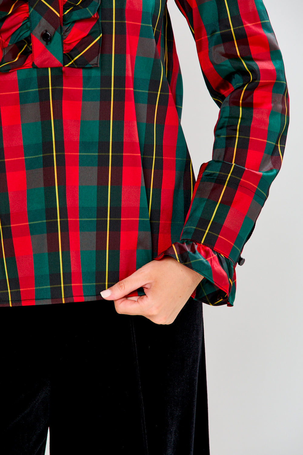 Red and green plaid shirt with a white background