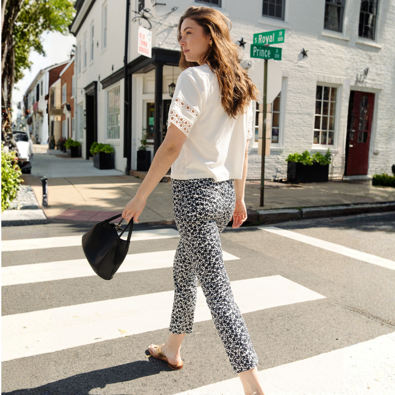 Woman is wearing the Olive top and The Mallory Pant in Black Daises