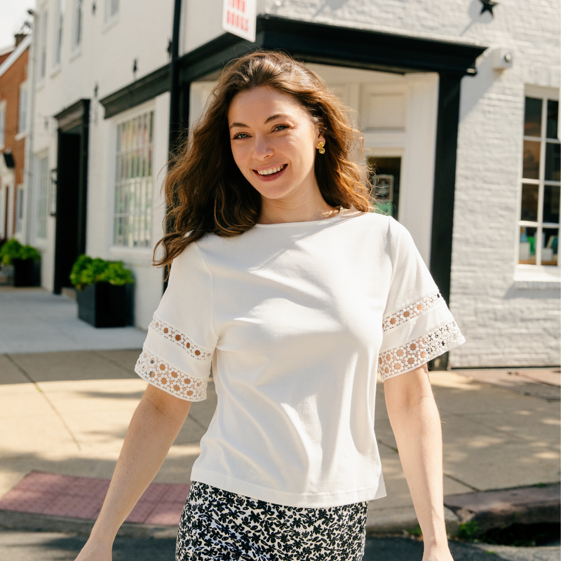 A woman wearing the Olive Top