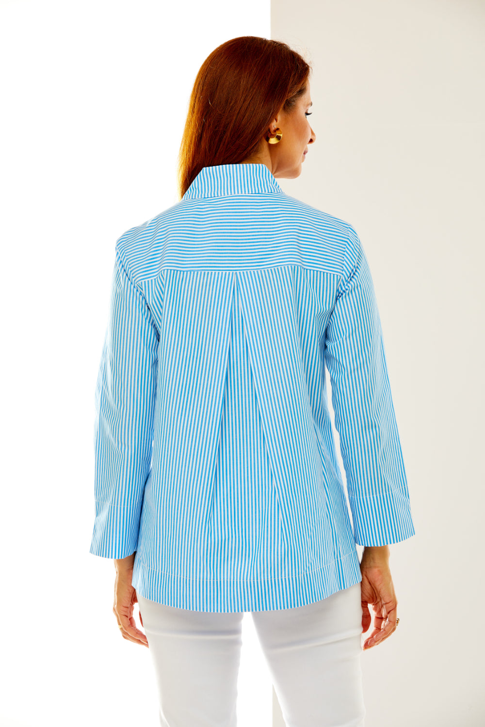 Woman in ocean and white stripe shirt
