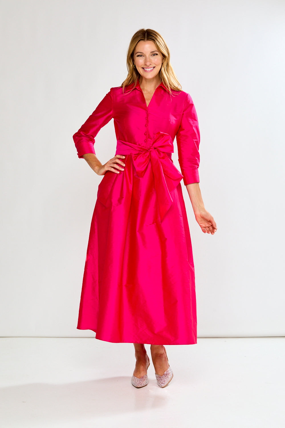 Woman wearing a Fuchsia dress on a white background
