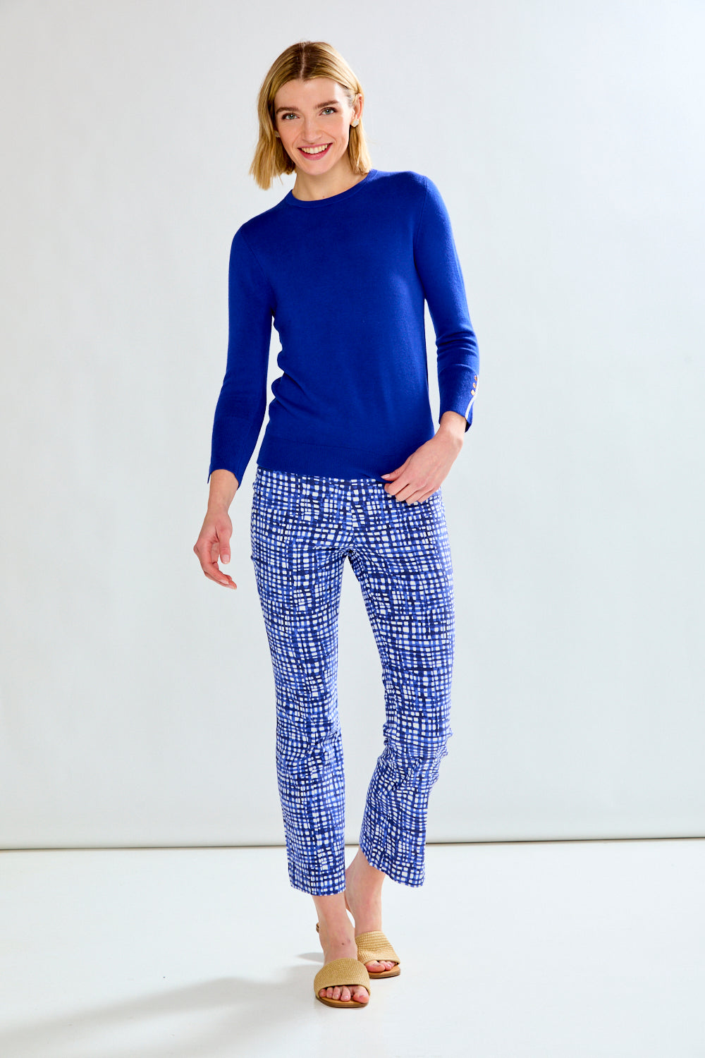 woman in sweater and patterned pants
