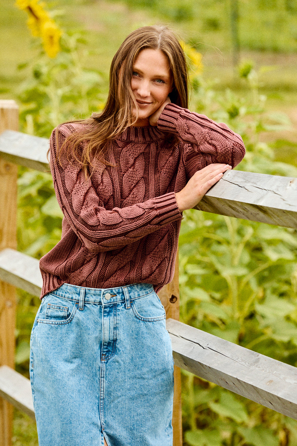 Woman wearing a raisin colored sweater