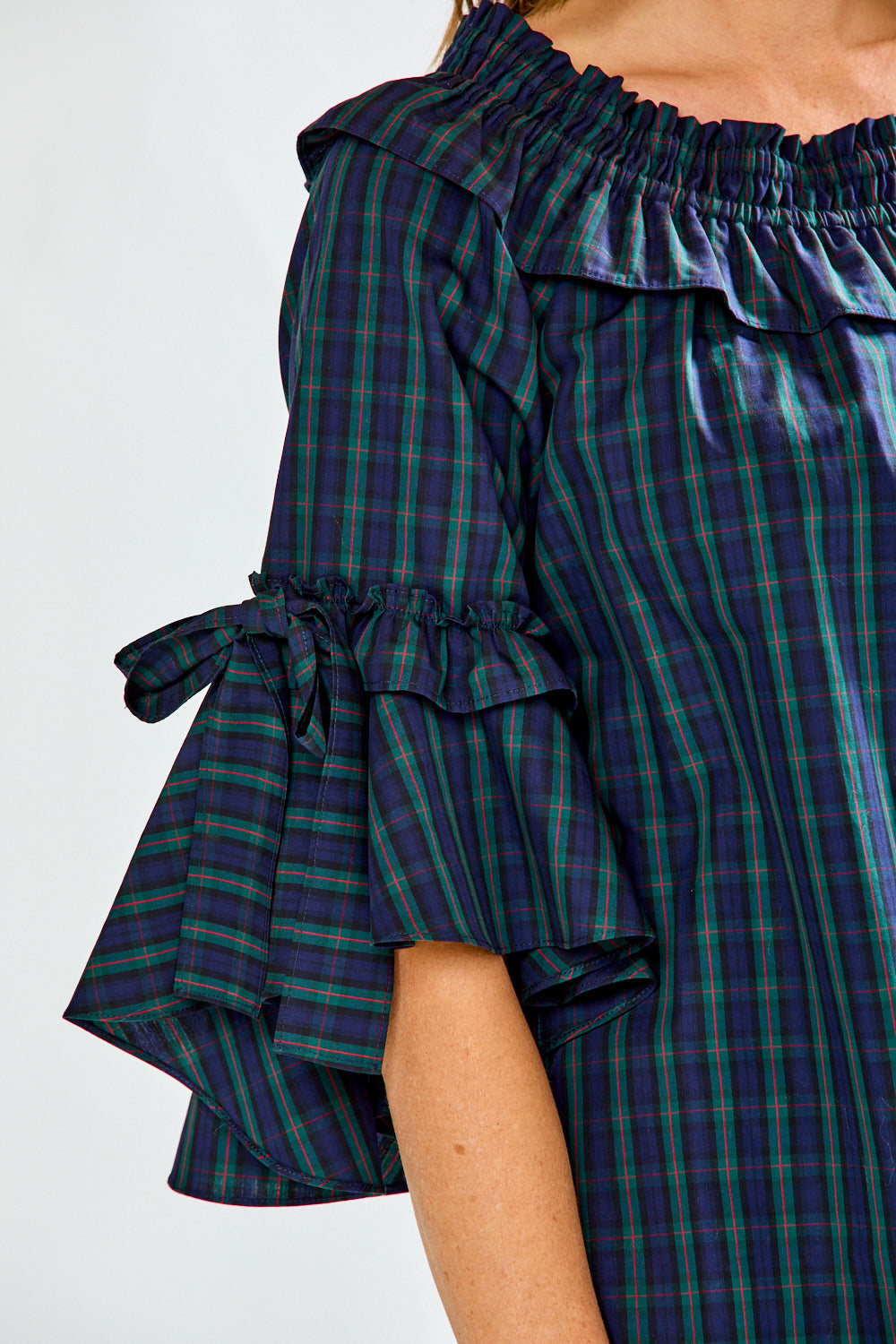 Woman in plaid on/off shoulder top