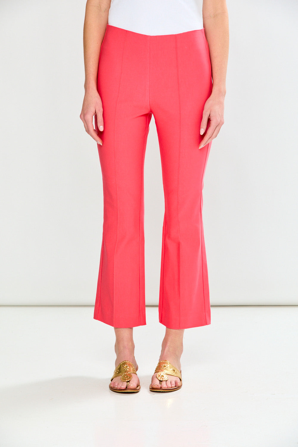 Person wearing guava pants on a white background