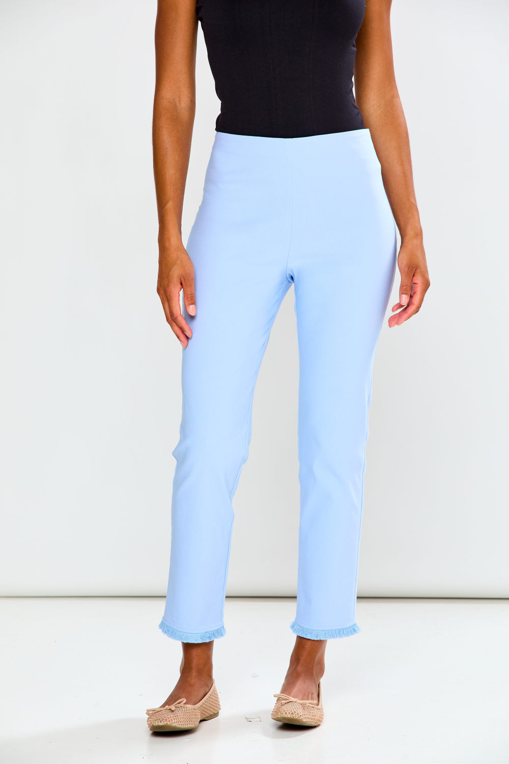 Light blue pants worn by a person on a white background