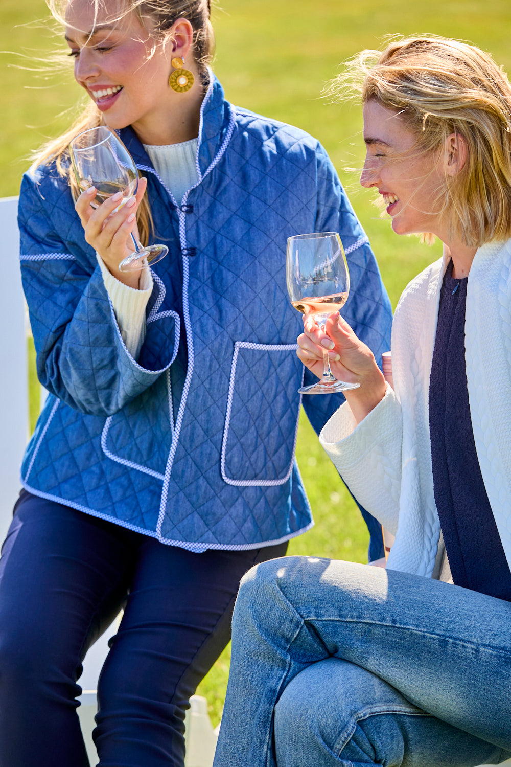 Woman wearing a blue quilted jacket standing outside a building.
