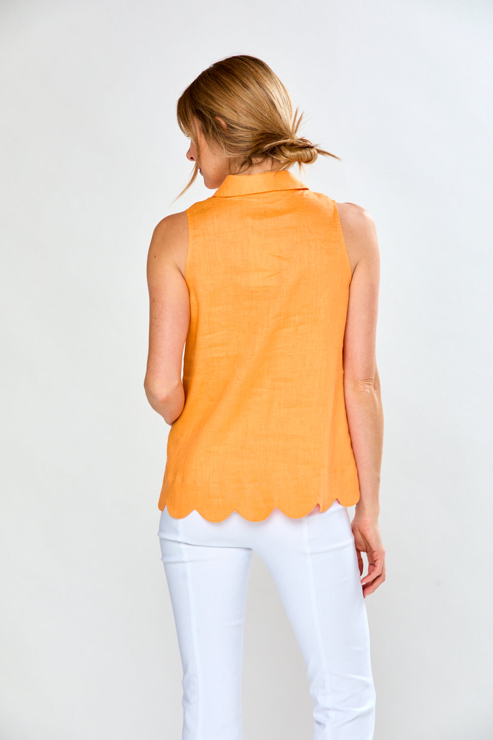 Woman in mandarin sleeveless blouse