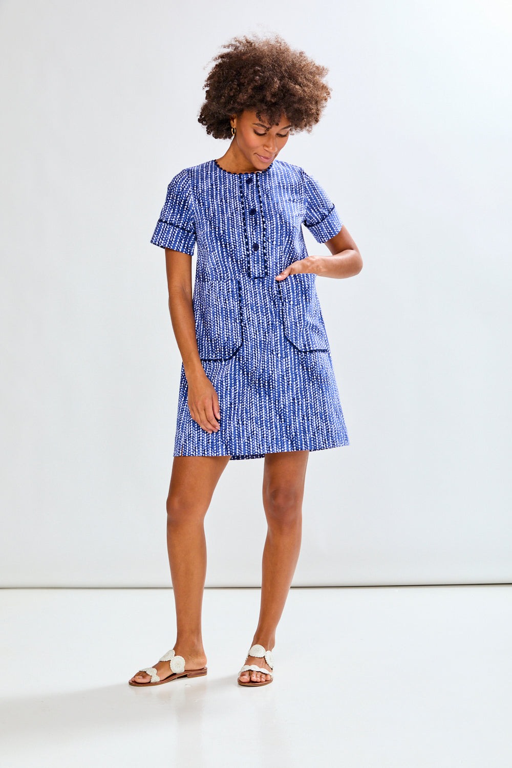 Woman wearing a blue dress with a white background