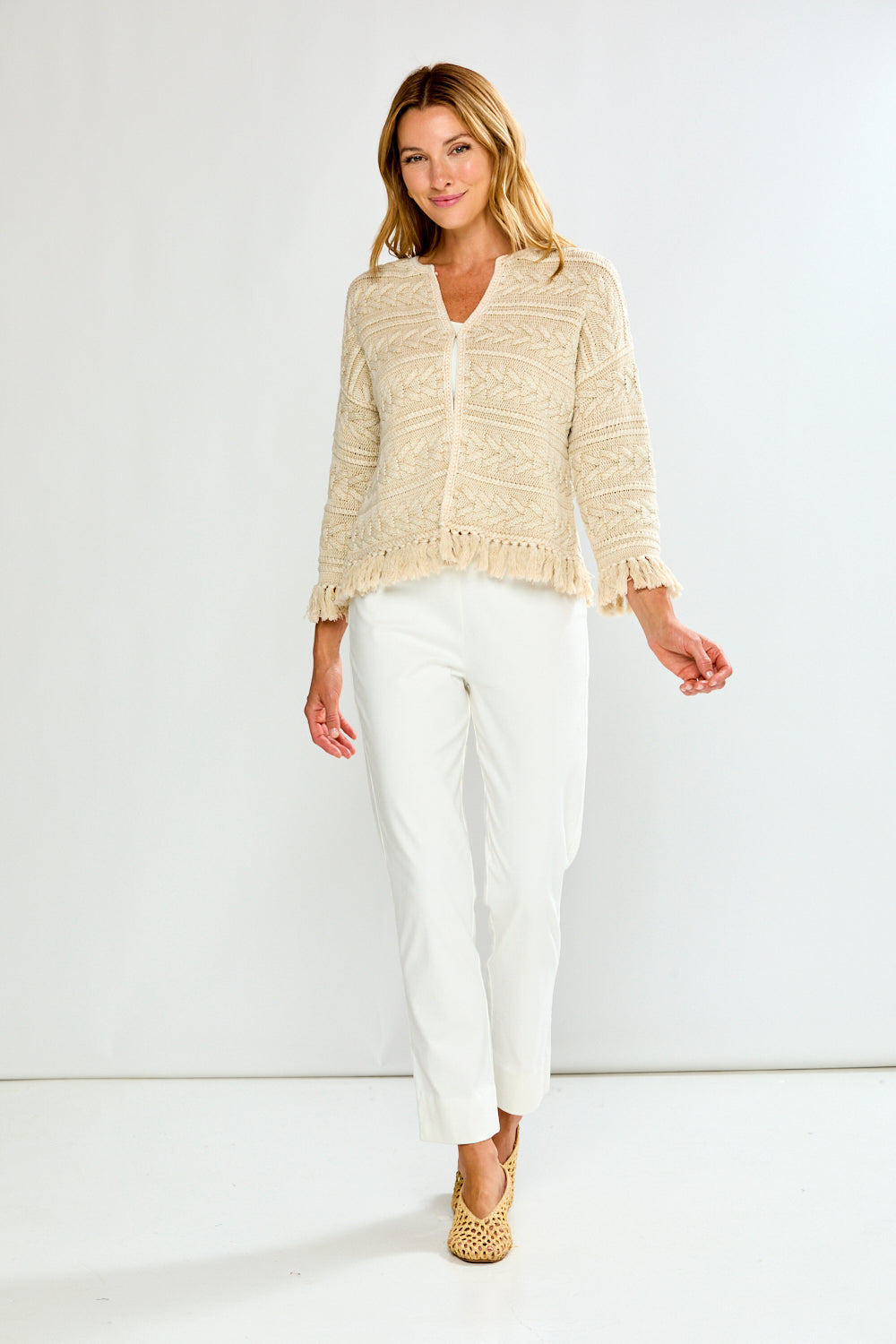 Woman in pebble cardigan with white pants