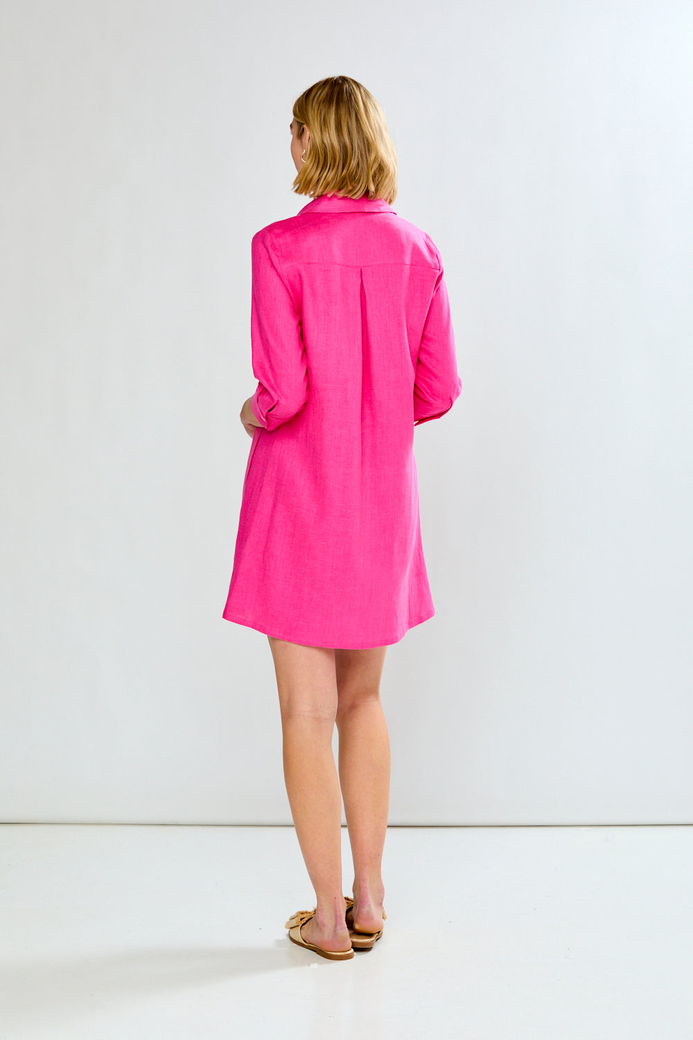 Woman wearing a pink dress against a white background