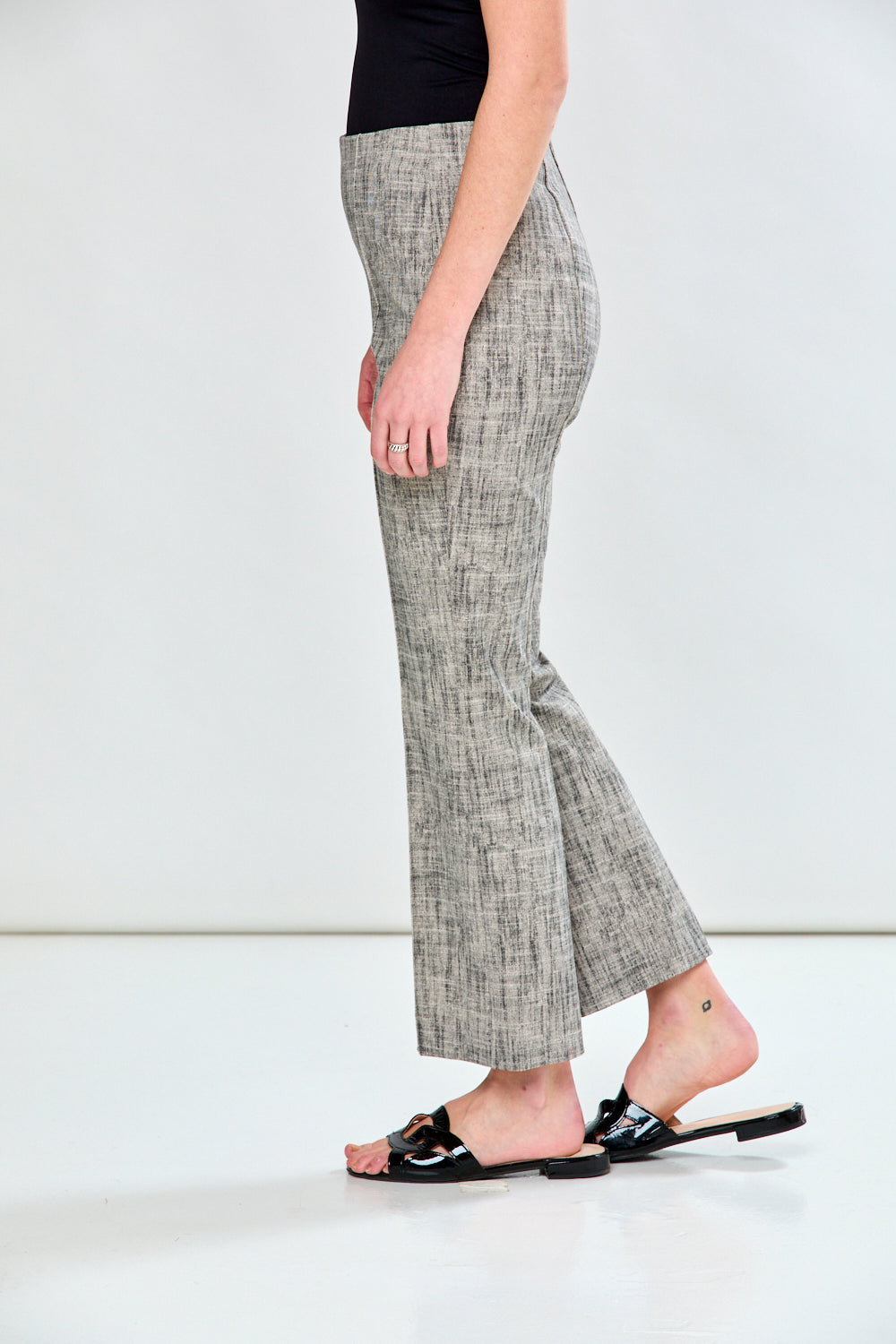 Woman in sand and black pants