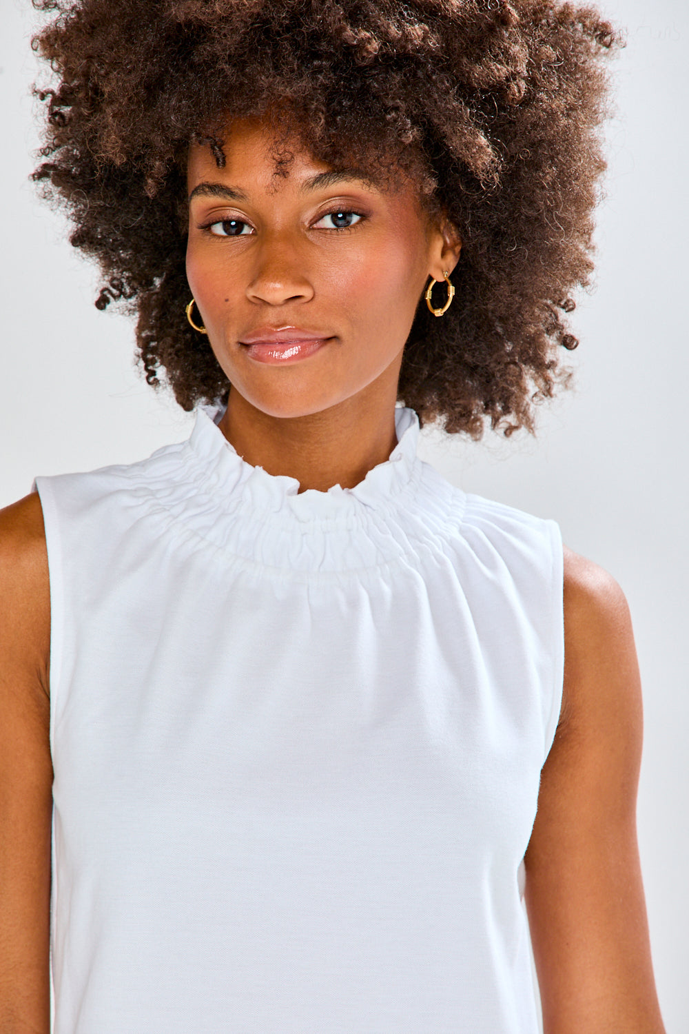 Woman in white top and patterned pants