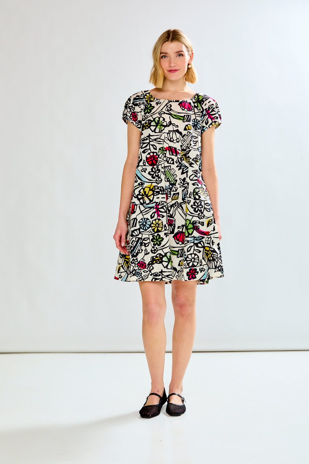 Woman wearing a printed dress on a white background