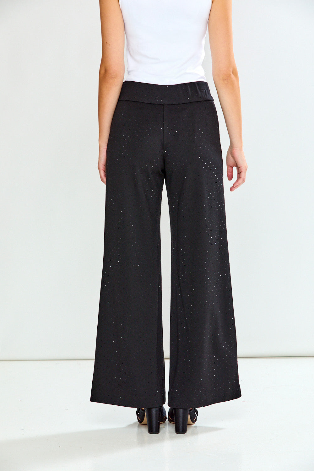 Black wide-leg pants worn by a person on a white background