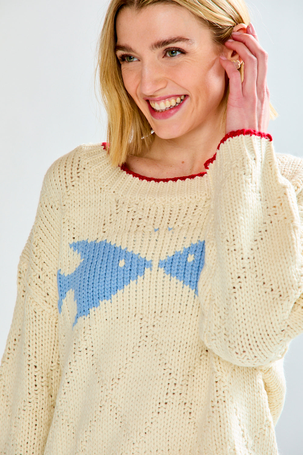 Woman with cream fish sweater on